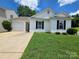 Charming single-story home with well-manicured lawn and attached single-car garage at 7315 Fig Ln, Charlotte, NC 28215