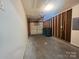 Spacious garage with partial drywall showcasing framing and a roll up door at 7315 Fig Ln, Charlotte, NC 28215
