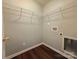 Bright laundry room featuring wood-look vinyl flooring and a wire rack storage shelf above the utility connections at 7315 Fig Ln, Charlotte, NC 28215