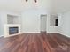 Bright living room featuring a fireplace and laminate flooring at 7315 Fig Ln, Charlotte, NC 28215