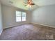 Spacious main bedroom with large windows and neutral carpet at 7315 Fig Ln, Charlotte, NC 28215