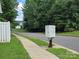 Street view with mailbox and sidewalk surrounded by lush greenery and shade trees at 7315 Fig Ln, Charlotte, NC 28215