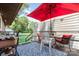 Inviting back deck with outdoor seating under a red umbrella for shade at 816 Radio Rd, Statesville, NC 28677