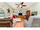 Spacious living room features laminate flooring, neutral green paint, and ceiling fan at 816 Radio Rd, Statesville, NC 28677