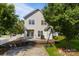 View of the backyard that includes a concrete patio, steps up to the grass, and a basketball hoop at 9704 Grier Springs Ln, Charlotte, NC 28213