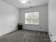 Bedroom with neutral carpet, window and overhead lighting at 9704 Grier Springs Ln, Charlotte, NC 28213