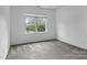 Empty bedroom with neutral carpet and window at 9704 Grier Springs Ln, Charlotte, NC 28213