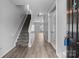 Spacious foyer with hardwood floors, staircase, and ample natural light at 9704 Grier Springs Ln, Charlotte, NC 28213