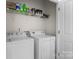 Laundry room with washer and dryer, plus storage shelves at 9704 Grier Springs Ln, Charlotte, NC 28213