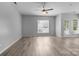Bright living room with hardwood floors and ample natural light from large windows at 9704 Grier Springs Ln, Charlotte, NC 28213