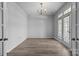 Bright living room with ample natural light from French doors and a chandelier at 9704 Grier Springs Ln, Charlotte, NC 28213