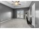 Spacious primary bedroom features ceiling fan, carpet, and french doors to the outside at 9704 Grier Springs Ln, Charlotte, NC 28213