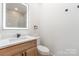 Bathroom with a vanity and modern fixtures, a lighted mirror, and a toilet at 101 Bryan St, Kannapolis, NC 28083