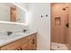 Modern bathroom with a double sink vanity with an lighted mirror and a tiled walk-in shower at 101 Bryan St, Kannapolis, NC 28083