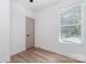 Bright bedroom features wood-look floors, a ceiling fan, and natural light from a large window at 101 Bryan St, Kannapolis, NC 28083