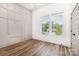Light-filled bedroom with wood floors, modern wall accents, and a view of the outdoors at 101 Bryan St, Kannapolis, NC 28083