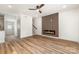 Bright living room with wood floors, fireplace accent wall, and a ceiling fan at 101 Bryan St, Kannapolis, NC 28083