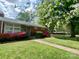 Lovely ranch home with stone accents, colorful azaleas, and a well-maintained lawn at 1017 Andover Rd, Charlotte, NC 28211