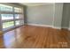 Inviting living room with hardwood floors and a wall of windows offering bright natural light at 1017 Andover Rd, Charlotte, NC 28211