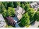 Aerial view of the brick home with a long driveway and mature trees surrounding the property at 10320 Lemington Dr, Mint Hill, NC 28227