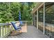 Inviting back deck featuring rocking chairs, screened-in porch and private wooded views for ultimate relaxation at 10320 Lemington Dr, Mint Hill, NC 28227