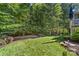 View of the backyard with mature trees providing shade and privacy at 10320 Lemington Dr, Mint Hill, NC 28227