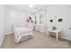 Cozy bedroom with a playful theme, featuring a cute bed, small table and chairs, and bright window at 10320 Lemington Dr, Mint Hill, NC 28227