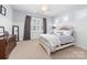 Bright bedroom featuring paneled walls, a decorative ceiling fan, and lots of natural light at 10320 Lemington Dr, Mint Hill, NC 28227