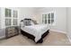 Cozy bedroom with bright, natural light, neutral paint, and elegant decor at 10320 Lemington Dr, Mint Hill, NC 28227