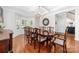 Bright dining room featuring hardwood floors, large bay window, and a spacious dining table at 10320 Lemington Dr, Mint Hill, NC 28227