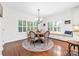 Charming dining area with a round table, chandelier, and window seating at 10320 Lemington Dr, Mint Hill, NC 28227
