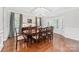 Elegant dining room with hardwood floors, coffered ceiling, bay window, and ample seating at 10320 Lemington Dr, Mint Hill, NC 28227