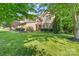 Charming brick home with well-maintained landscaping and mature trees in the front yard at 10320 Lemington Dr, Mint Hill, NC 28227