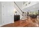 Inviting foyer with a staircase, hardwood floors, and views into the living room at 10320 Lemington Dr, Mint Hill, NC 28227