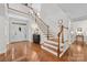Bright foyer with hardwood floors, staircase, and ample natural light flowing in at 10320 Lemington Dr, Mint Hill, NC 28227