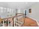 Light-filled hallway showcases hardwood floors and elegant white trim detailing at 10320 Lemington Dr, Mint Hill, NC 28227