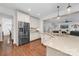 Stylish kitchen showcasing a center island with a sink, stainless steel refrigerator, and granite countertops at 10320 Lemington Dr, Mint Hill, NC 28227