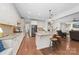 Open concept kitchen with a center island, breakfast bar, and access to the living area at 10320 Lemington Dr, Mint Hill, NC 28227