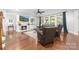 Cozy living room with fireplace, built-in shelves, hardwood floors, and comfortable seating at 10320 Lemington Dr, Mint Hill, NC 28227