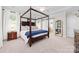 Spacious primary bedroom with trey ceilings, and large windows allowing for abundant natural light at 10320 Lemington Dr, Mint Hill, NC 28227