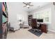 Bright home office with custom built-in shelving, comfortable seating, and natural light at 10320 Lemington Dr, Mint Hill, NC 28227