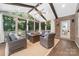 Inviting sunroom with ample seating, exposed beams, and a ceiling fan at 10320 Lemington Dr, Mint Hill, NC 28227