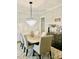 Elegant dining room featuring modern chandelier, wainscoting, and neutral decor at 104 Bunker Way, Mooresville, NC 28117