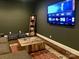 Entertainment room with a large TV, wooden accents, and cozy seating area at 104 Bunker Way, Mooresville, NC 28117