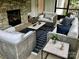 Comfortable seating area on a screened porch with a stone fireplace at 104 Bunker Way, Mooresville, NC 28117