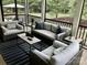 Inviting screened porch with wicker furniture, perfect for outdoor relaxation at 104 Bunker Way, Mooresville, NC 28117