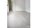 Spacious bedroom featuring neutral carpeting and an adjoining walk-in closet at 10607 Old Bridge Ln, Charlotte, NC 28269