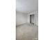 Large bedroom with neutral carpeting and a double-door closet for ample storage at 10607 Old Bridge Ln, Charlotte, NC 28269