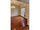 Elegant dining room showcasing hardwood floors, wainscoting, and a chandelier at 10607 Old Bridge Ln, Charlotte, NC 28269