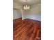 Elegant dining room showcasing hardwood floors, wainscoting, and a chandelier at 10607 Old Bridge Ln, Charlotte, NC 28269